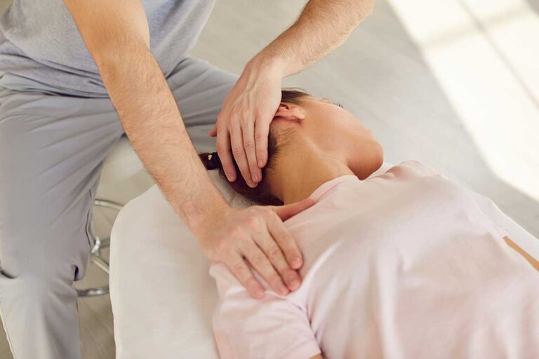 A chiropractor gently examines a patient's neck during a consultation in a comfortable clinic setting.