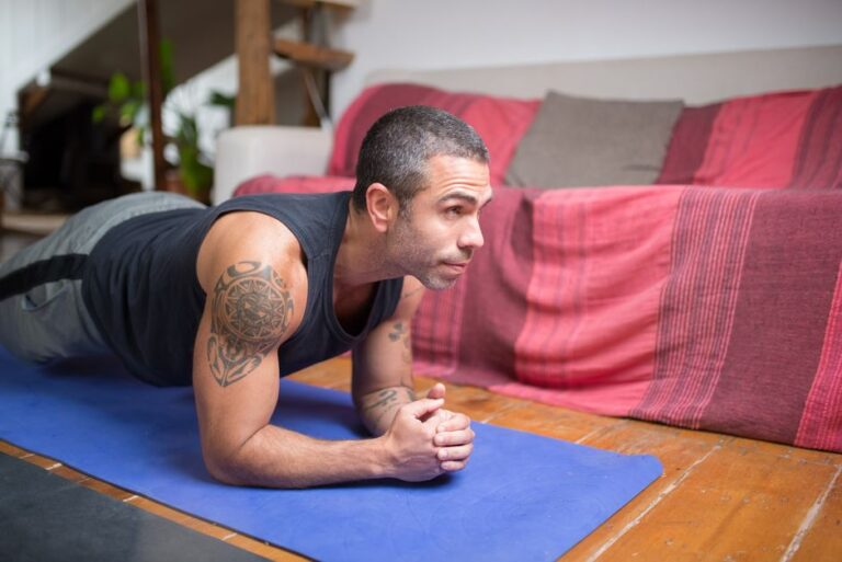 Person performing a controlled core exercise on a mat while maintaining a neutral spine